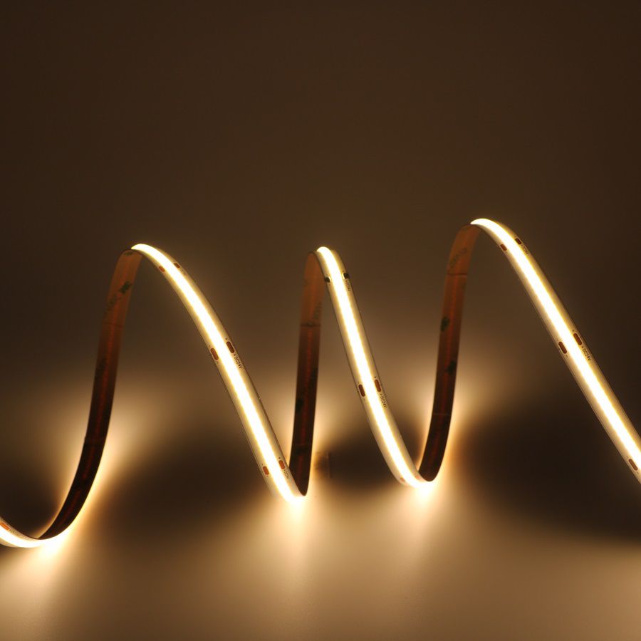 Flexible ultra-long COB LED strip forming waves of warm white light